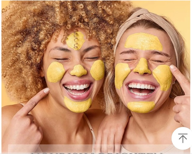 Two women wearing a yellow clay face mask